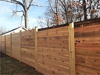 <b>6 foot Horizontal cedar stepped fencing with no spacing between the pickets with standard black post caps</b>